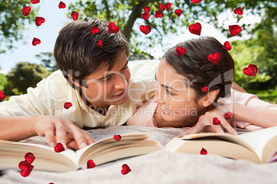 Composite image of two friends looking at each other while readi