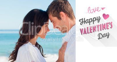 Composite image of attractive couple embracing on the beach