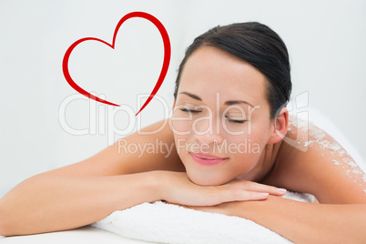 Composite image of peaceful brunette lying with salt scrub on ba