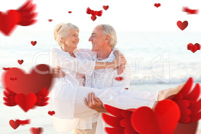Composite image of man carrying his wife on the beach