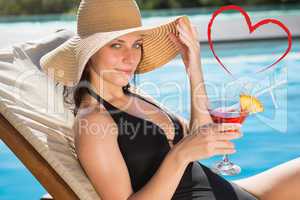 Composite image of beautiful woman holding drink by swimming poo