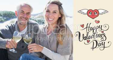 Composite image of couple enjoying white wine on picnic at the b