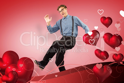Composite image of geeky hipster walking and looking at camera