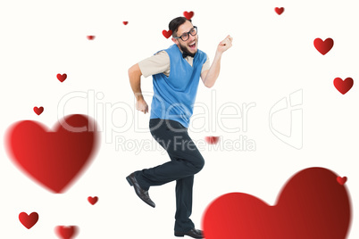 Composite image of geeky hipster dancing and smiling