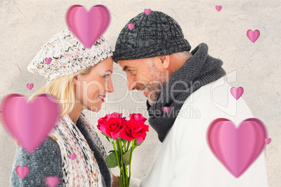 Composite image of smiling couple in winter fashion posing with