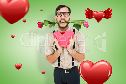 Composite image of geeky hipster offering valentines gifts