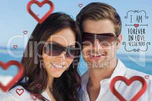 Composite image of smiling couple wearing sunglasses and looking