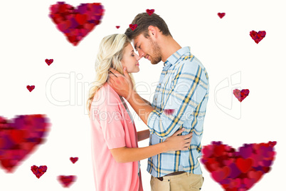 Composite image of attractive couple smiling at each other and h