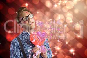 Composite image of geeky hipster covered in kisses