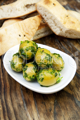 green olives with fresh bread and herbs