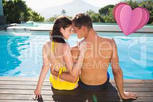 Composite image of couple sitting by swimming pool on a sunny da