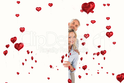 Composite image of happy couple showing large poster