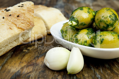 green olives with fresh bread and herbs