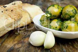 green olives with fresh bread and herbs