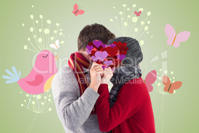 Composite image of couple holding a red heart