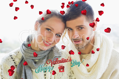 Composite image of close up portrait of a loving couple in winte