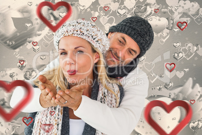 Composite image of smiling couple in winter fashion posing