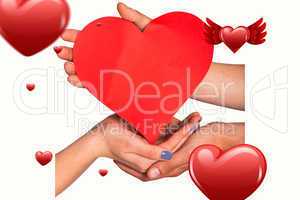 Composite image of hands holding red heart