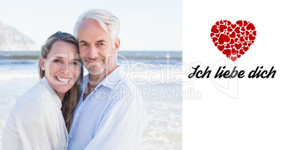 Composite image of happy couple hugging on the beach