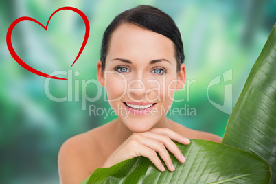 Composite image of beautiful nude brunette posing with green lea