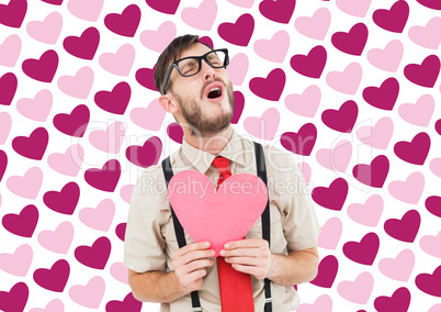 Composite image of geeky hipster crying and holding heart card