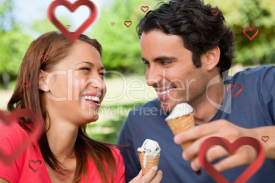 Composite image of two friends laughing while holding ice cream