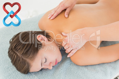 Composite image of attractive young woman receiving shoulder mas