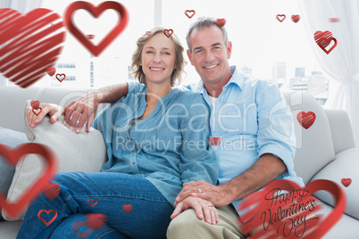 Composite image of middle aged couple relaxing on the couch