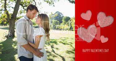 Composite image of smiling couple standing and embracing in park