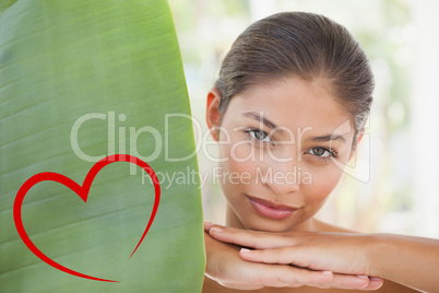 Composite image of beautiful brunette smiling at camera