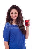 beautiful smiling brunette woman is drinking red juice