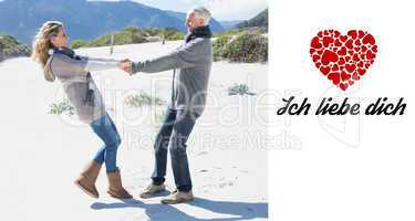 Composite image of smiling couple spinning on the beach in warm