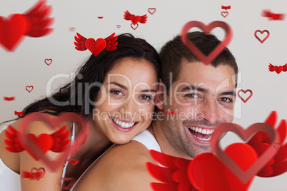 Composite image of young couple smiling at camera