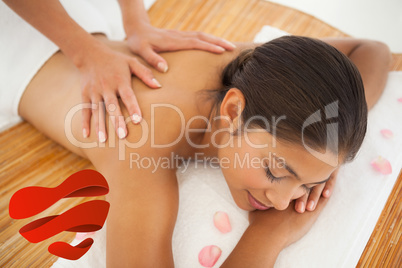 Composite image of beautiful brunette enjoying a back massage