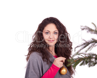 beautiful brunette woman is decorating a christmas tree