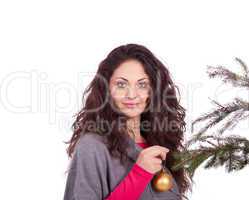 beautiful brunette woman is decorating a christmas tree