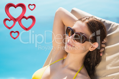 Composite image of cheerful woman by swimming pool