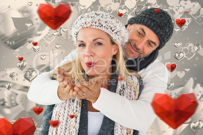 Composite image of smiling couple in winter fashion posing