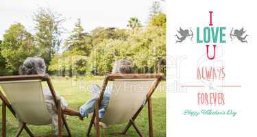 Composite image of happy mature couple sitting in park