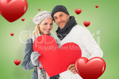 Composite image of smiling couple in winter fashion posing with