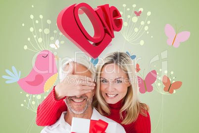 Composite image of loving couple with gift