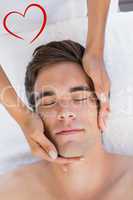 Composite image of man receiving facial massage at spa center