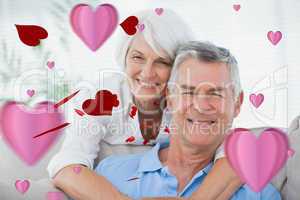 Composite image of portrait of a woman hugging husband