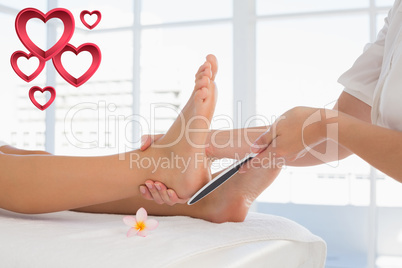 Composite image of side view of a young woman receiving pedicure