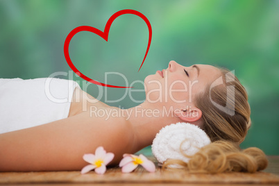 Composite image of peaceful blonde lying on bamboo mat with flow
