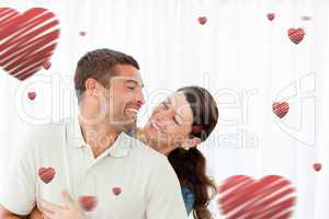 Composite image of lovely couple laughing together in the living