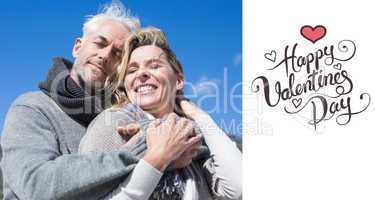 Composite image of carefree couple hugging in warm clothing