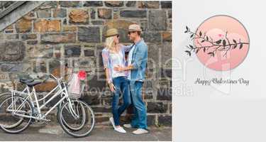 Composite image of hip young couple hugging by brick wall with t