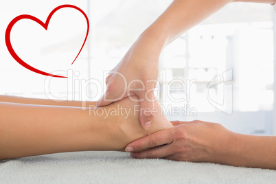 Composite image of woman receiving leg massage at spa center
