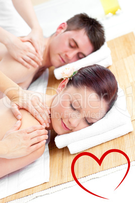 Composite image of attractive young couple receiving a back mass